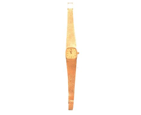 Omega - a lady's 9 carat yellow gold bracelet watch, gold coloured cushion shaped baton dial in a 9 carat yellow gold case wi