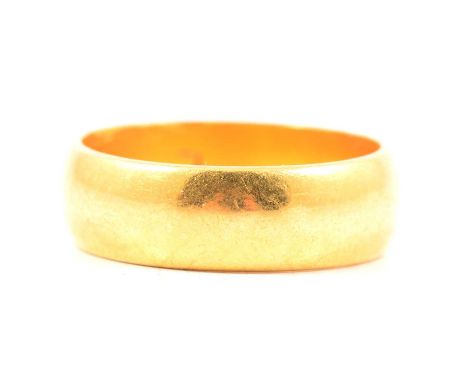 A 22 carat yellow gold wedding band, 5.8mm wide plain polished D shape ring size K, Birmingham 1965, 6.4g