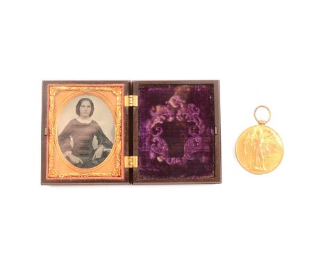 A bakelite case with Victorian photograph, each side of the case carved with am angel to the oval centre surrounded by floral