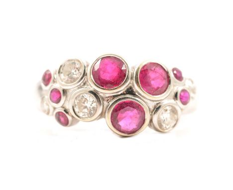 A ruby and diamond bubble ring, eight Sri Lankan (Ceylon) rubies and five brilliant cut diamonds rubbed over set in an 18 car