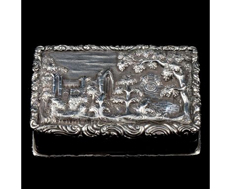 A William IV silver castle top snuff box by Joseph Willmore, Birmingham 1833, the cover depicting Dryburgh Abbey in high reli