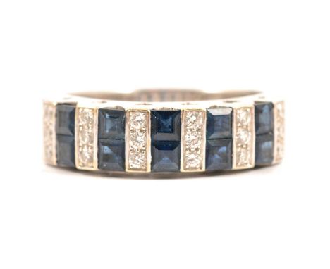 A sapphire and diamond half hoop ring, ten pairs of square cut sapphires channel set vertically and spaced by six groups of t