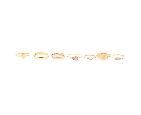 Seven gold rings, a 9 carat yellow, red and white gold Russian style wedding ring size K, 2.8g; a 9 carat yellow gold wedding
