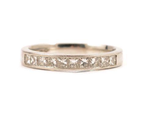 A diamond half eternity ring, ten princess cut stones channel set in a platinum 3mm wide band with closed back setting ring s