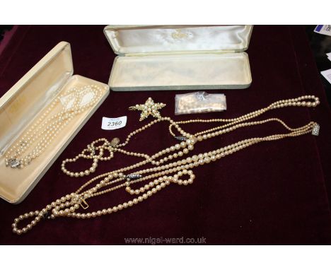 A quantity of simulated pearl necklaces including one marked silver lotus to clasp.