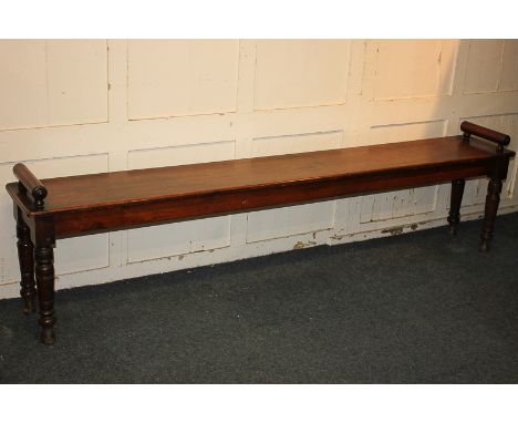 A Victorian long bench, with cylindrical end supports, on turned baluster legs, 205cm