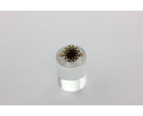 A pearl and garnet cluster ring in 9ct yellow gold