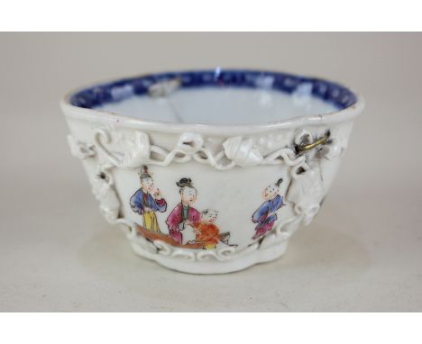 A Chinese porcelain libation cup, oval form with opposing panels of figures, with raised scroll borders, old riveted repair, 