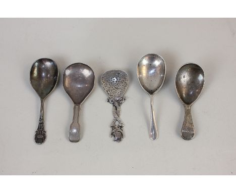 A George VI Scottish silver caddy spoon with dolphin twist handle and ship finial, Glasgow 1937, together with three other si