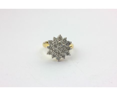 A diamond cluster ring, claw set with round brilliant cuts in yellow gold