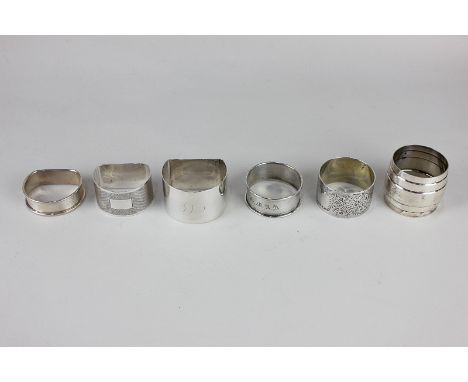 Five George VI and later silver napkin rings and an 800 white metal napkin ring, 4oz gross