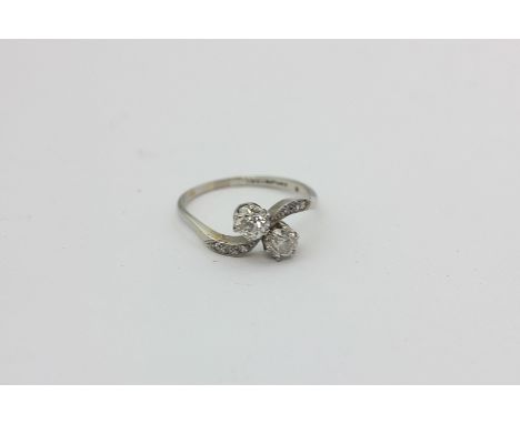 A diamond crossover ring, the old cuts with eight cuts to each shoulder on platinum