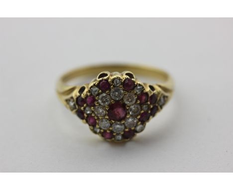 A ruby and diamond cluster ring set with rose cut and circular cut stones