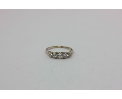 A diamond five-stone ring claw set with graduated old cut stones in white on yellow gold, London 1896