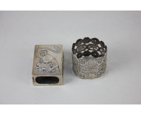 A Chinese white metal napkin ring, the pierced form decorated with character marks, together with a Chinese white metal match