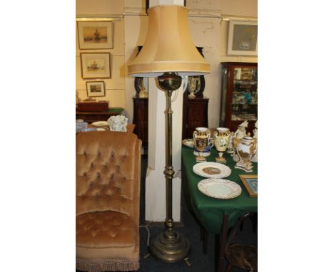 A Victorian brass standard lamp converted from an oil lamp, circular base on three feet, 150cm