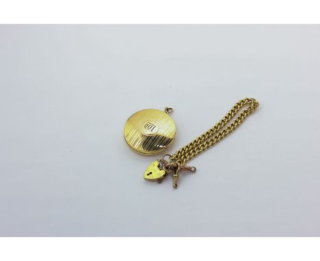 An 18ct gold curb link bracelet with 9ct gold padlock, 24.6g, and a 9ct gold engine turned locket