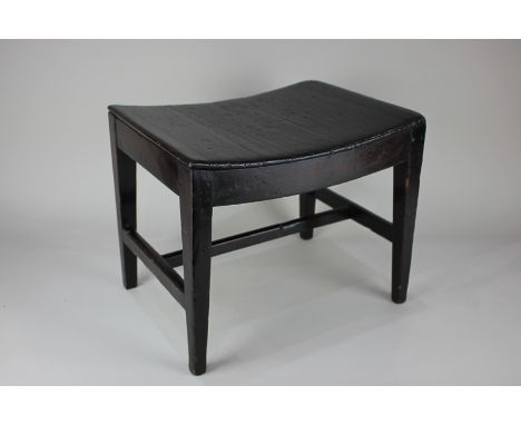 A 19th century mahogany stool with shaped wooden seat on tapered legs, 34.5cm