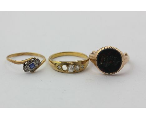 A sapphire and diamond crossover ring, an old cut diamond ring (one missing), and a bloodstone signet ring