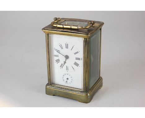 A brass and bevelled glass cased carriage clock, the white enamel dial with Roman numerals and subsidiary second dial, 15cm, 