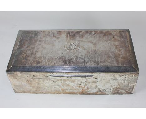 A George V silver cigar box, rectangular shape with engine turned top with chamfered edges, the centre with engraved initials