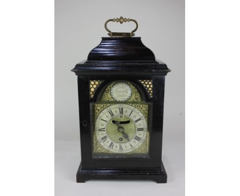 A George II ebonised bracket clock with 6 inch gilt metal break arch dial, marked John Everell, London, single fusee movement