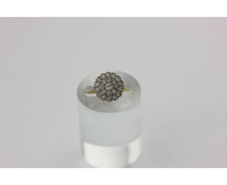 A diamond ring, the domed cluster set with old cut stones in 18ct gold