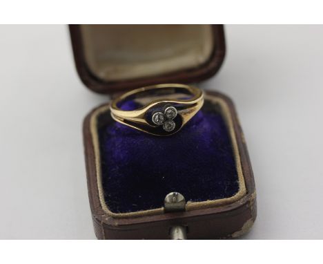 A diamond three-stone crossover ring in 18ct yellow gold