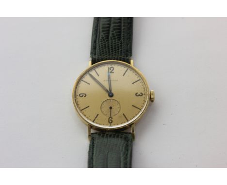 A gentleman's 18ct gold Longines wristwatch, manual movement with champagne dial
