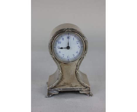 An Edward VII small silver cased mantel clock, white enamel circular dial, in balloon shaped case with ribbon and reed border