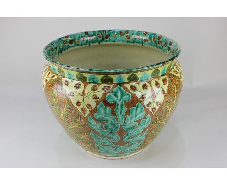 A Della Robbia pottery jardiniere of floral scrolling design, 29cm diameter, (a/f - significantly damaged)