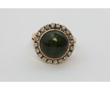 A cat's eye green tourmaline and diamond dress ring in 14ct 