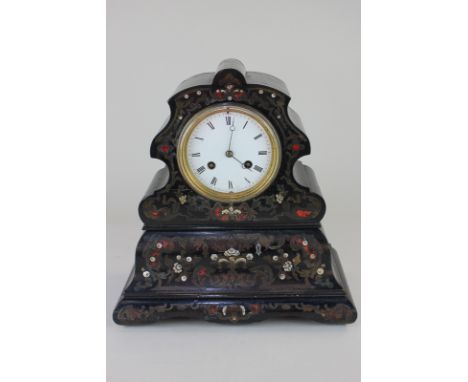 A 19th century black lacquered mantel clock, the scalloped case with brass, mother of pearl and tortoiseshell inlay, the move