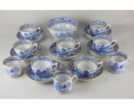 A 19th century blue and white porcelain part tea service, fluted shape with chinoiserie design and gilt borders, including se