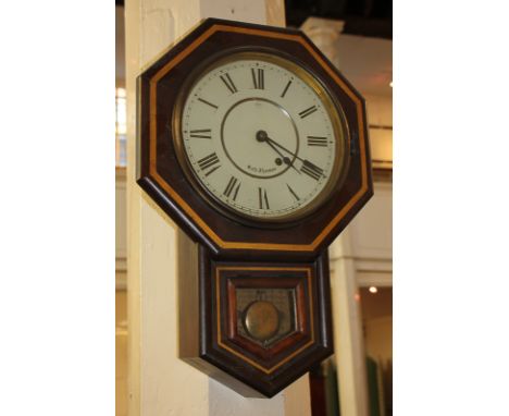 A Seth Thomas American drop-dial wall clock in octagonal shaped mahogany case, the circular enamel dial with Roman numerals, 