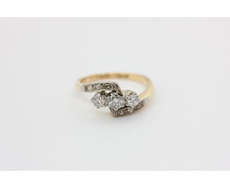 A diamond crossover ring, the three centre stones with diamond shoulders, in platinum on 18ct gold