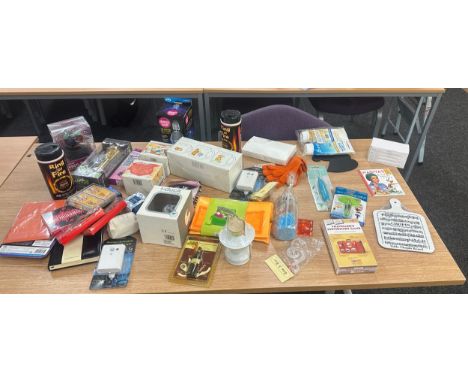 Box of new packaged items includes mugs, bottle openers, disco lights, sensor light, card games etc 