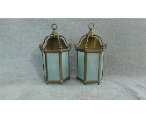A pair of brass hanging storm lanterns with light bulbs. Stamped to the back Lamp Art, Dept.   H.50cm 