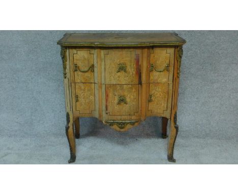 A 19th century Continental commode with floral marquetry inlay, brass lines and ormolu mounts. H.83 W.80 D.46cm (some veneer 