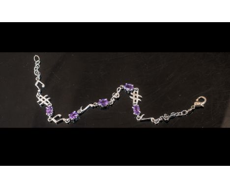 Amethyst Music Motif Station Bracelet, oval cut amethysts, claw set along a chain comprising treble clefs, notes and other mu