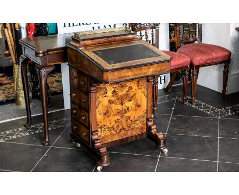 A Victorian Walnut Davenport of typical form. Fall front with fitted interior. Four drawers and dummy drawers, raised on bras
