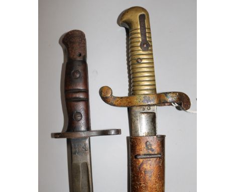 A French Yataghan bayonet and scabbard and a US WWI bayonet and scabbard dated 1917 by Remington