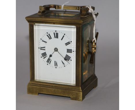A gilt brass carriage clock, late 19th/early 20th century, with eight day movement and white-enamelled dial