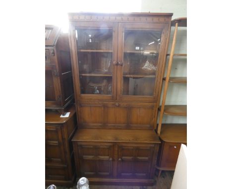 Ercol Golden Dawn, glazed two door bookcase with drinks compartment and cupboards under, 3'3 wide 