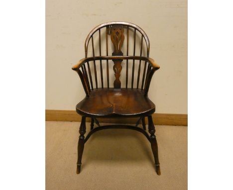 An oak Windsor stick back hooped elbow chair on Crinoline style base 