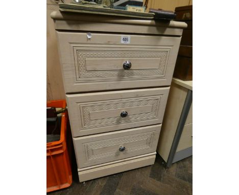 A three drawer light beech bedside chest matching the wardrobe 