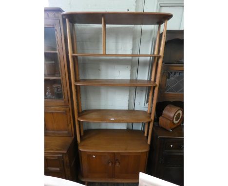 An Ercol pale oak room divider style open bookshelf with cupboards under, 33" wide 