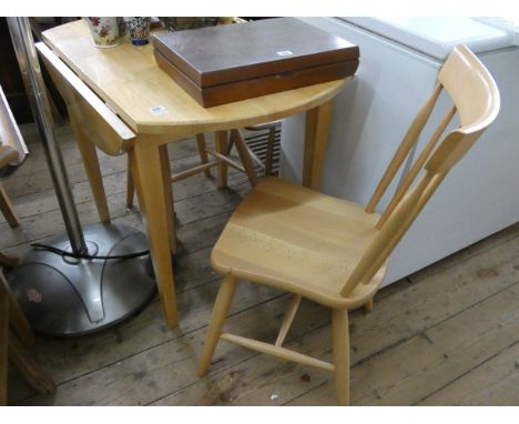 A modern light beech drop leaf kitchen table and a pair of matching stick back chairs 