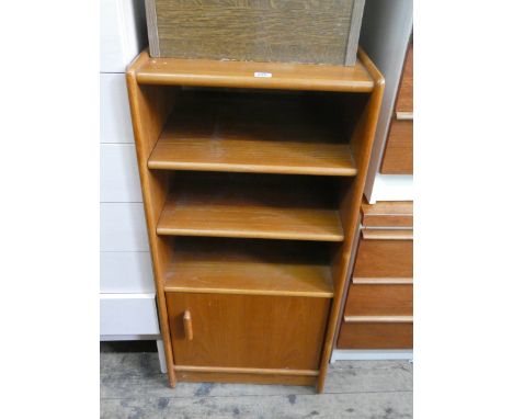 A teak shelf unit with cupboard in base, 19" wide 