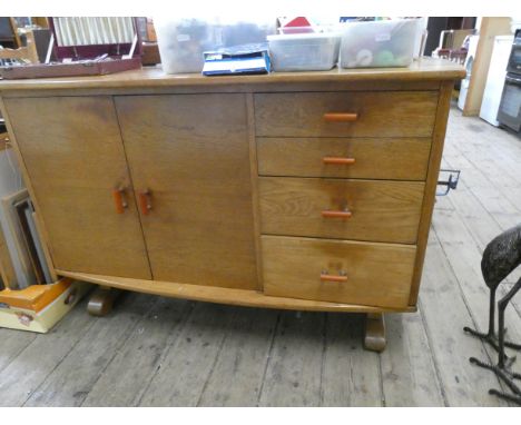 A chunky light oak dining suite comprising a drop leaf oval table, four slat back dining room chairs and an oak sideboard fit